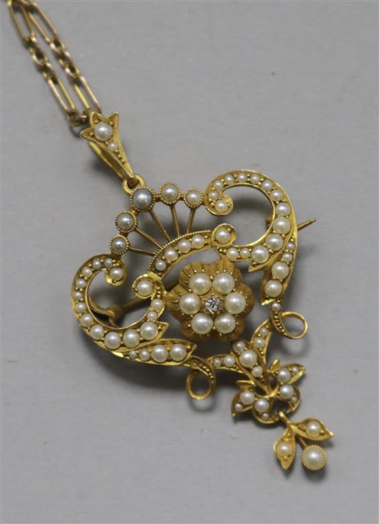 An Edwardian 15ct gold, seed pearl and diamond set pendant, on a 15ct gold chain, pendant 42mm.